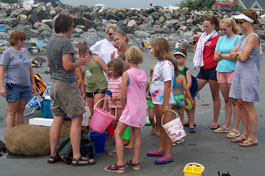A group gathers with Activity Director for ocean and tidal pool exploration.